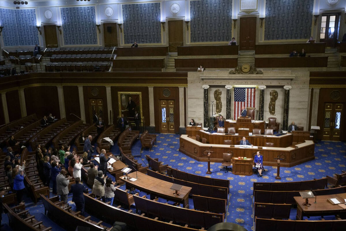 House Minority Leader Hakeem Jeffries, D-N.Y., left, speaks in the House chamber as House Democ ...