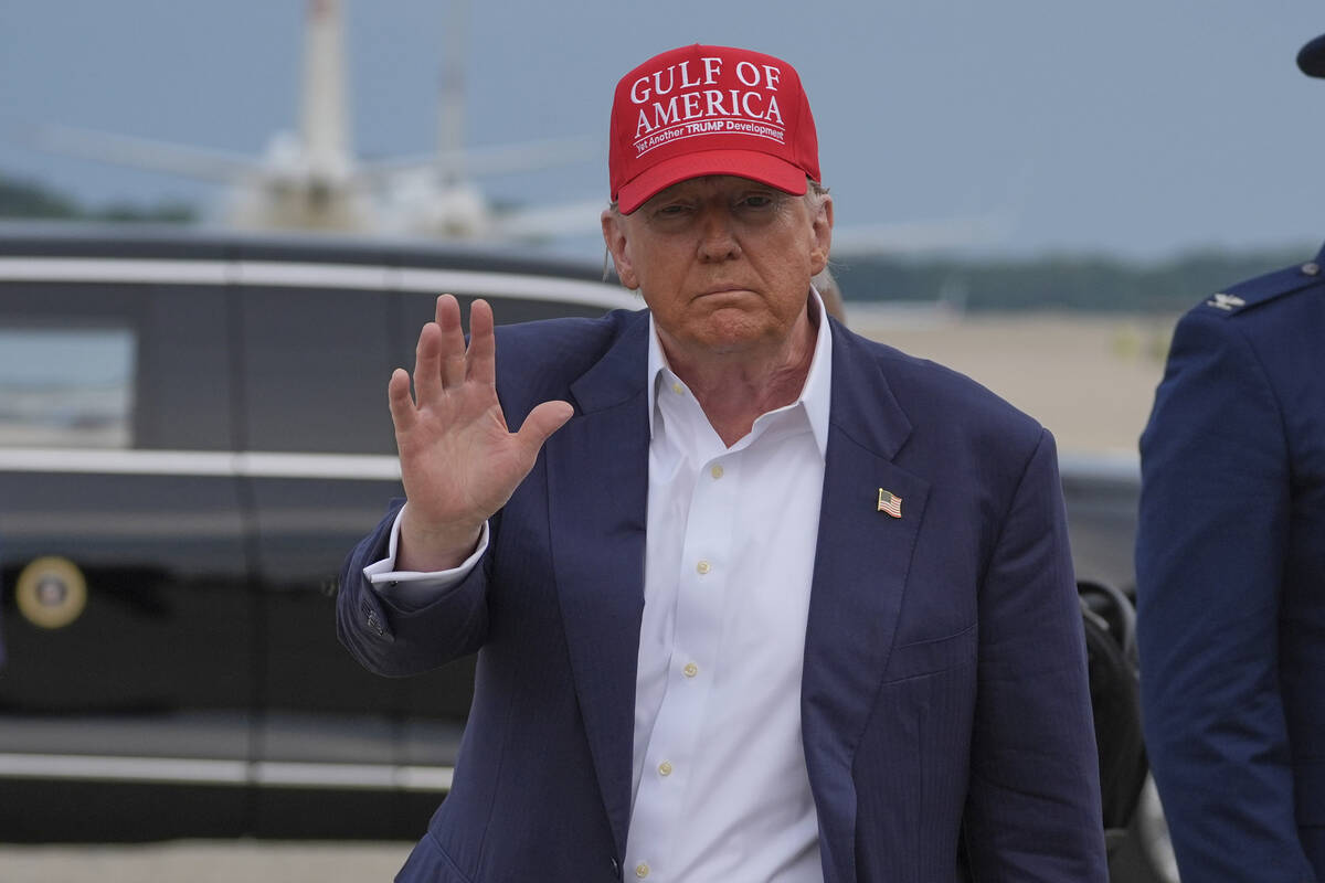 President Donald Trump waves as he arrives at Joint Base Andrews, Md., after visiting a migrant ...