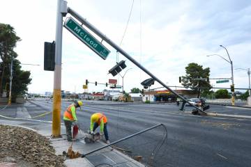 Workers clean up storm damage Wednesday, July 2, 2025, on Tropicana Avenue between McLeod Drive ...