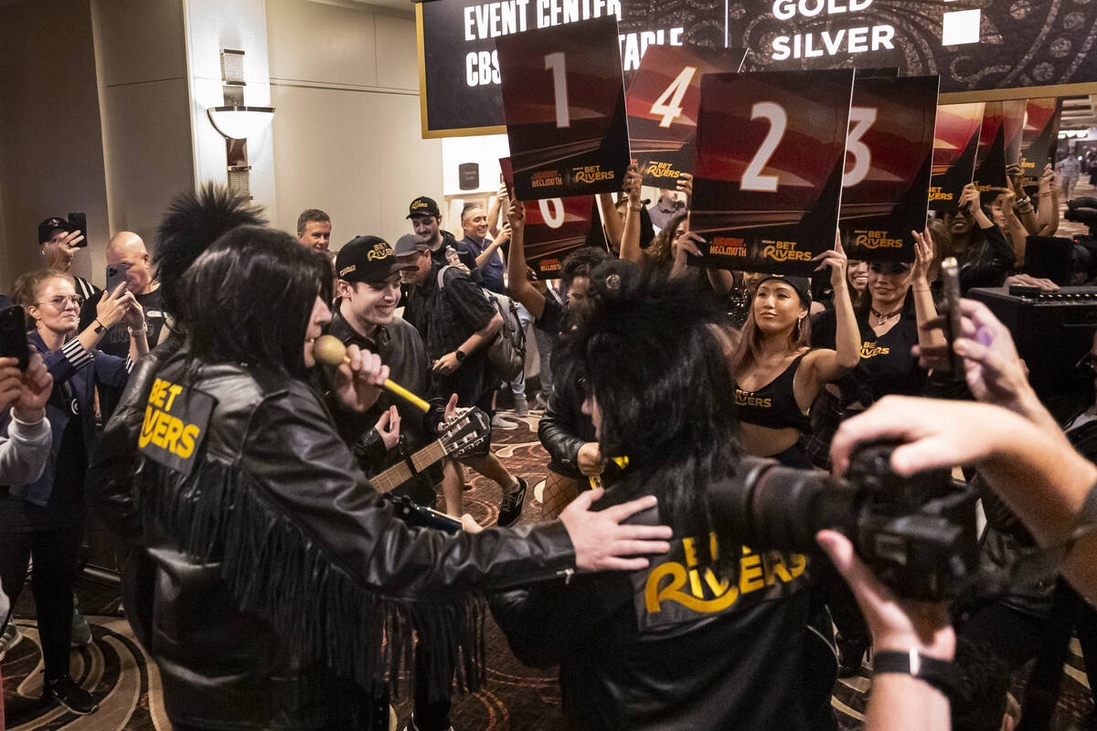 Phil Hellmuth, 17-time World Series of Poker champion, left, talks with his entourage before ma ...