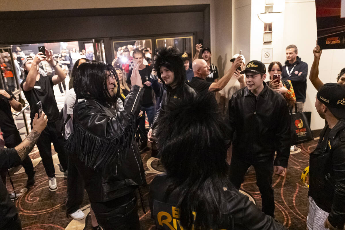 Phil Hellmuth, 17-time World Series of Poker champion, left, talks with his entourage before ma ...