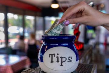 A dollar goes into the jar at the Water Street Pizzeria on Tuesday, May 20, 2025, in Henderson. ...