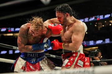 Julio Cesar Chavez Jr., right, punches Jake Paul during their cruiserweight boxing match on Sat ...