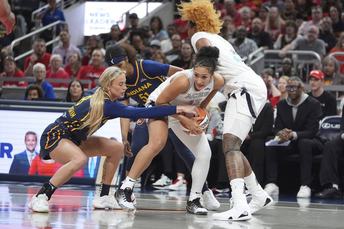 Las Vegas Aces' Aaliyah Nye (13) is defended by Indiana Fever's Sophie Cunningham (8) during th ...