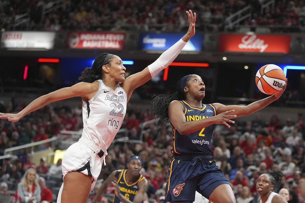 Indiana Fever's Aari McDonald (2) puts up a shot against Las Vegas Aces' A'ja Wilson (22) durin ...