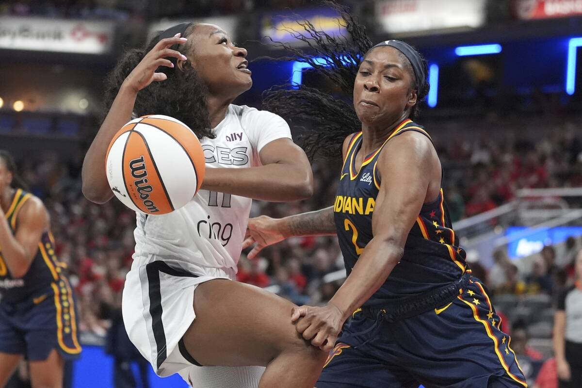 Las Vegas Aces' Dana Evans (11) goes to the basket against Indiana Fever's Aari McDonald (2) du ...