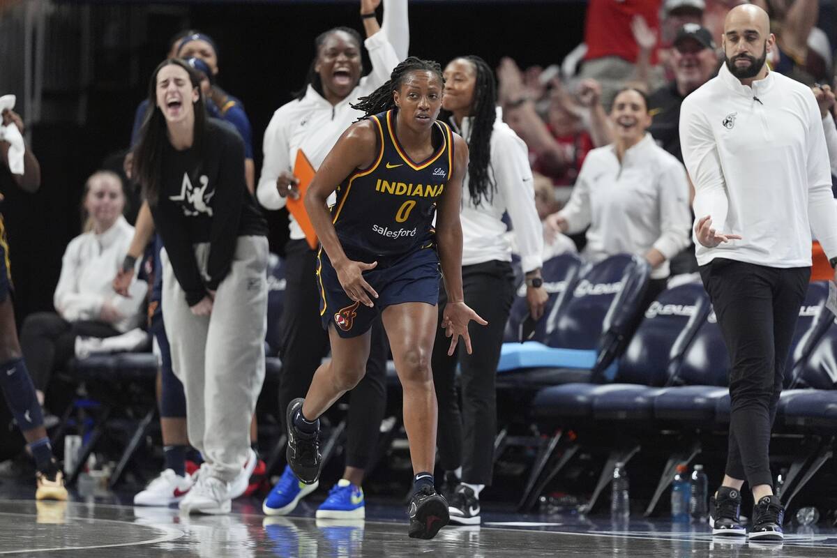Indiana Fever's Kelsey Mitchell (0) reacts after hitting a 3-point shot during the second half ...