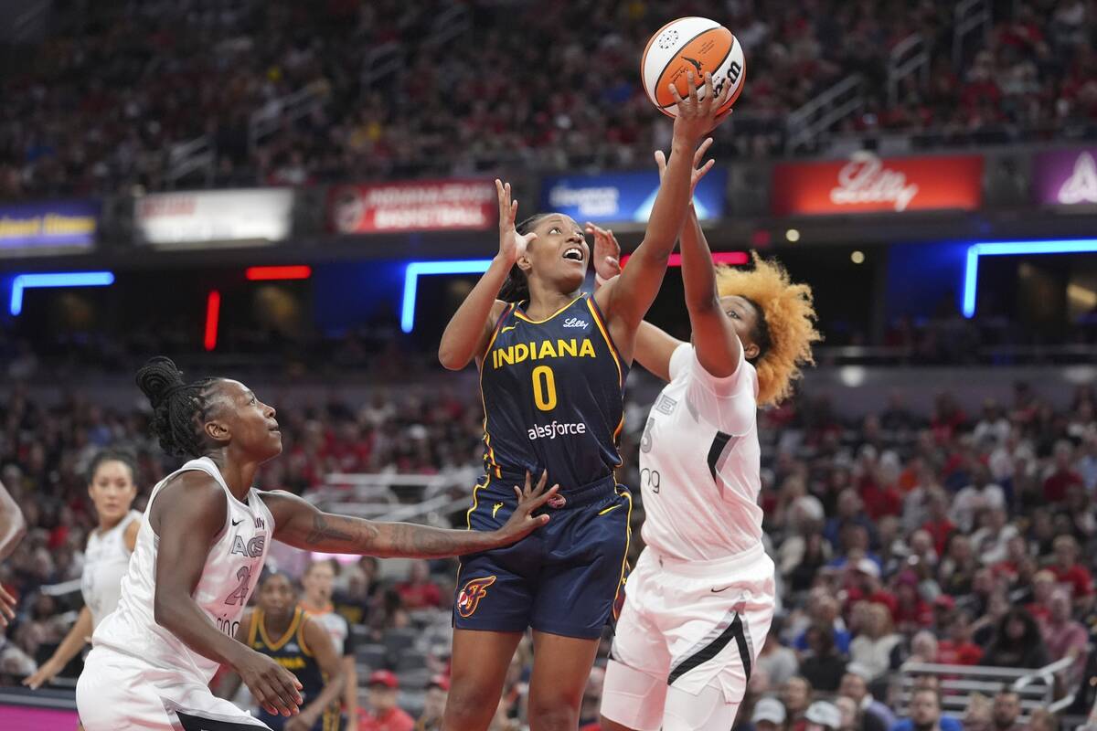Indiana Fever's Kelsey Mitchell (0) puts up a shot during the first half of a WNBA basketball g ...