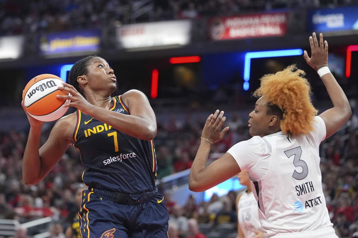 Indiana Fever's Aliyah Boston (7) shoots against Las Vegas Aces' NaLyssa Smith during the first ...