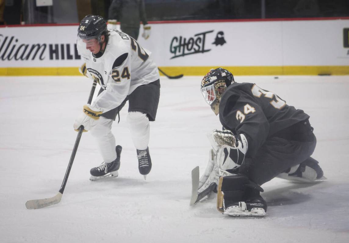 Golden Knights forward Trevor Connelly (24) tries to get around goaltender Stephen Peck (34) du ...