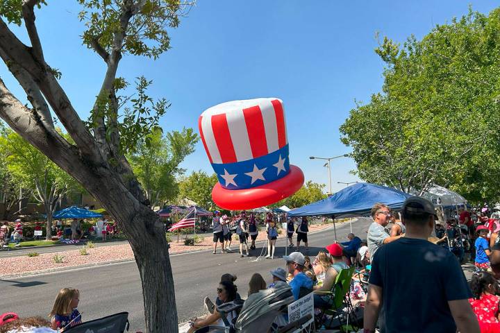 Volunteers carry a parade balloon of an Uncle Sam hat at the Summerlin Patriotic Parade on Frid ...