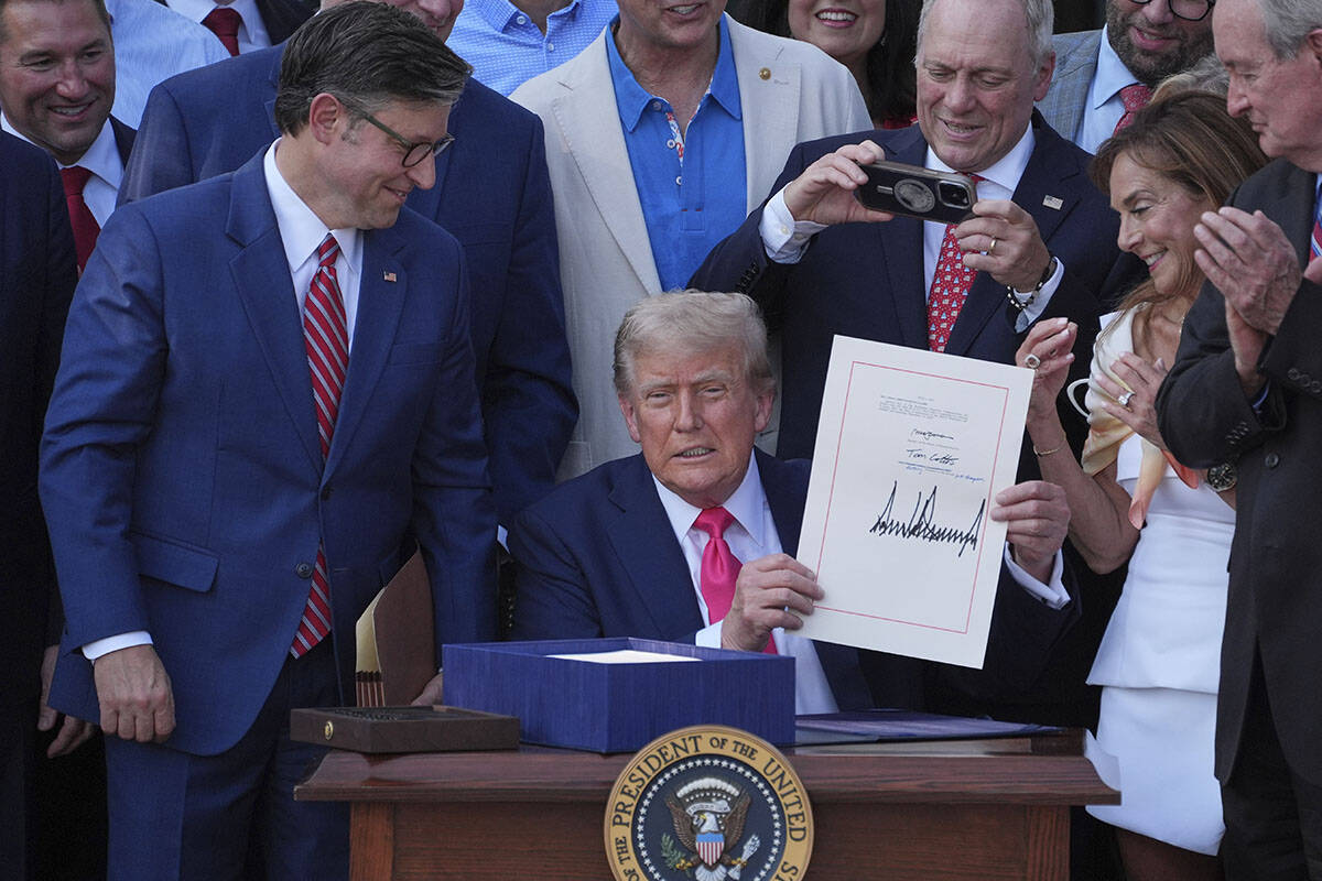 President Donald Trump holds his signed signature bill of tax breaks and spending cuts at the W ...