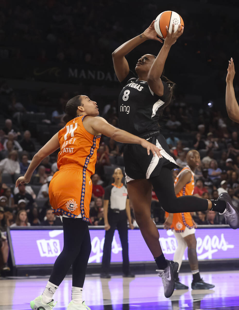 Aces forward Joyner Holmes (8) lays up the ball against Connecticut Sun guard Bria Hartley (14) ...