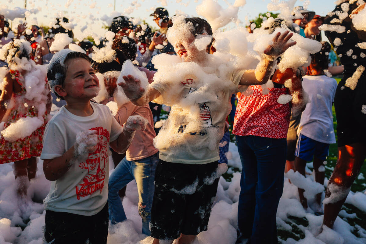 Kids play in a foam pit during a Fourth of July bash at Heritage Park Friday, July 4, 2025, in ...