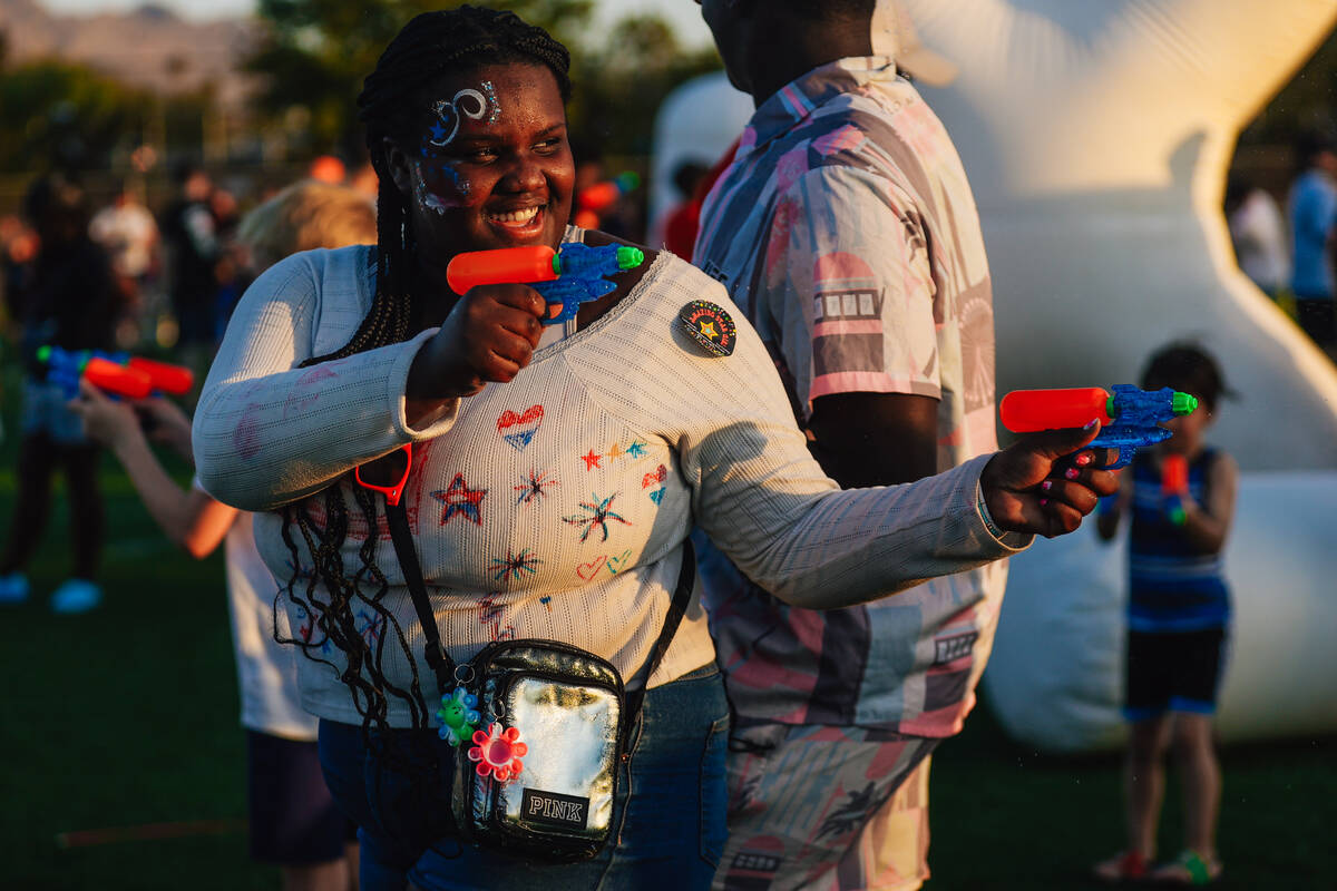 Water gun fights ensue during a Fourth of July bash at Heritage Park Friday, July 4, 2025, in H ...