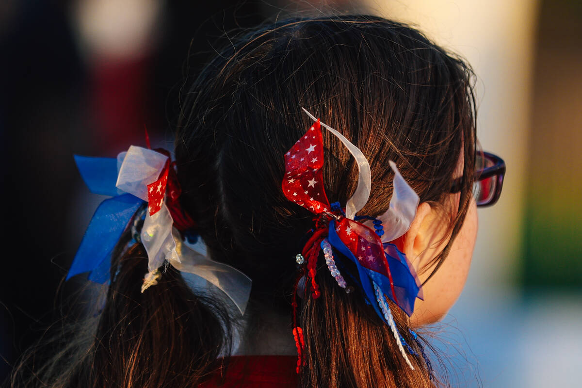 A child wears bows in her hair during a Fourth of July bash at Heritage Park Friday, July 4, 20 ...