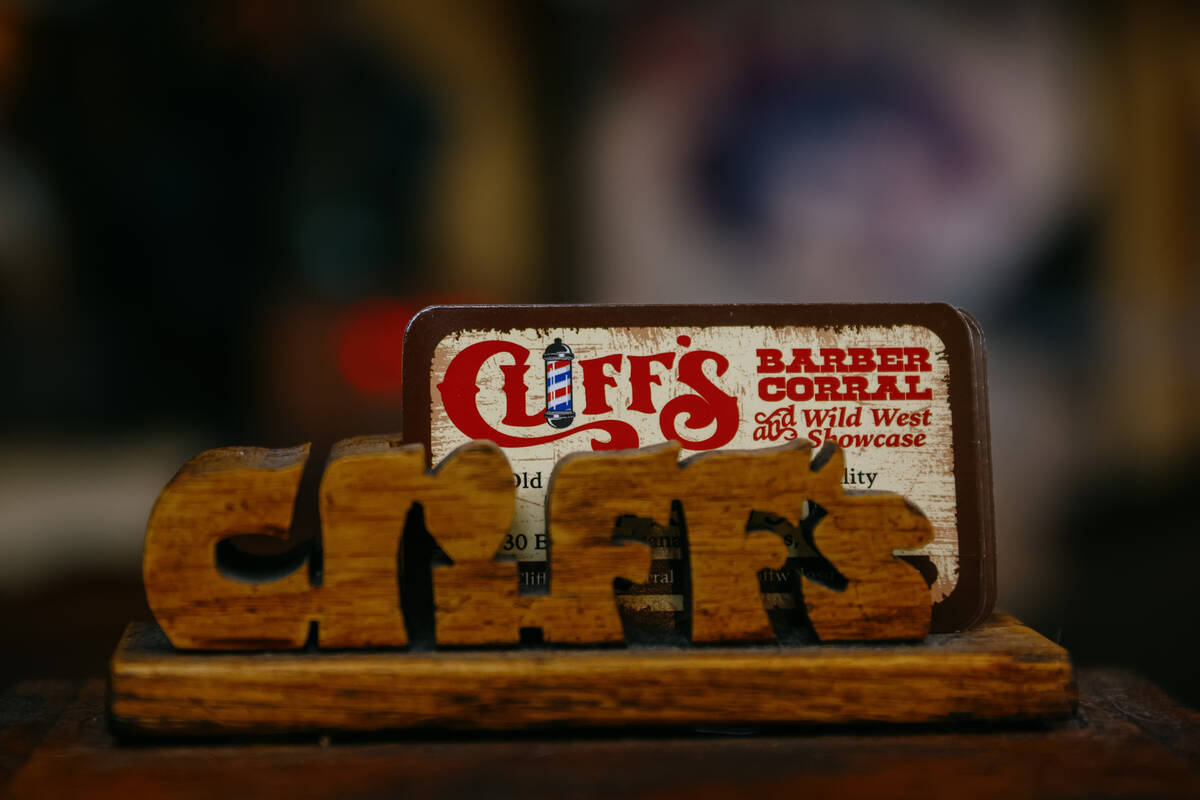 Business cards for Cliff’s Barber Corral sit atop a gumball machine on Saturday, July 5, 2025 ...
