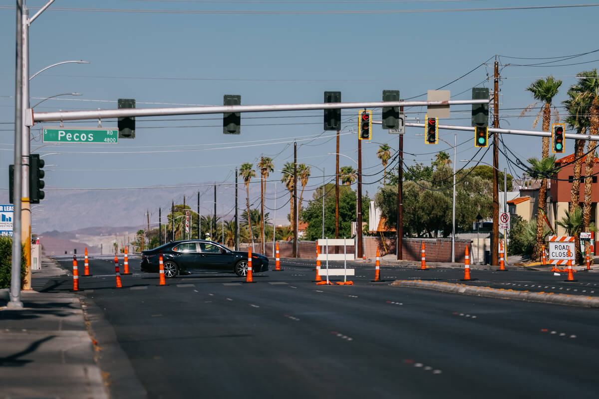 A car drives down Pecos Road, across a quiet, closed-down portion of Tropicana Avenue, before i ...