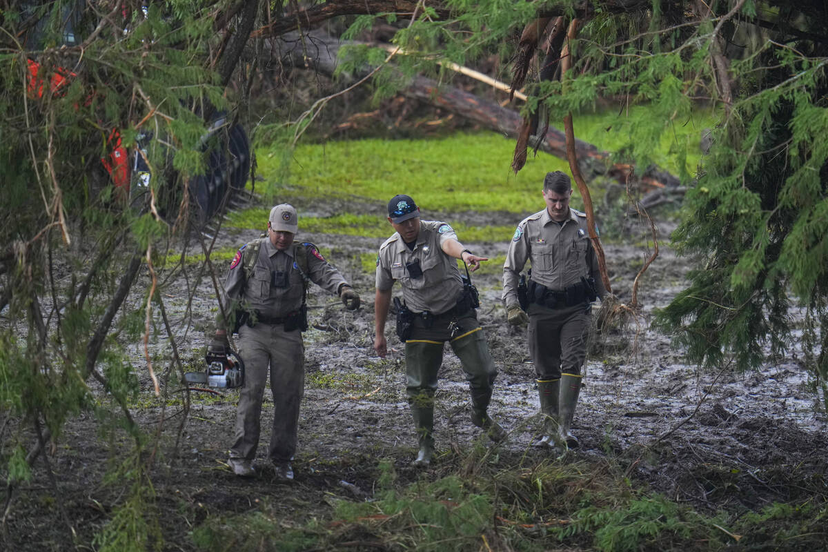 Officials inspect an area at Camp Mystic along the banks of the Guadalupe River after a flash f ...