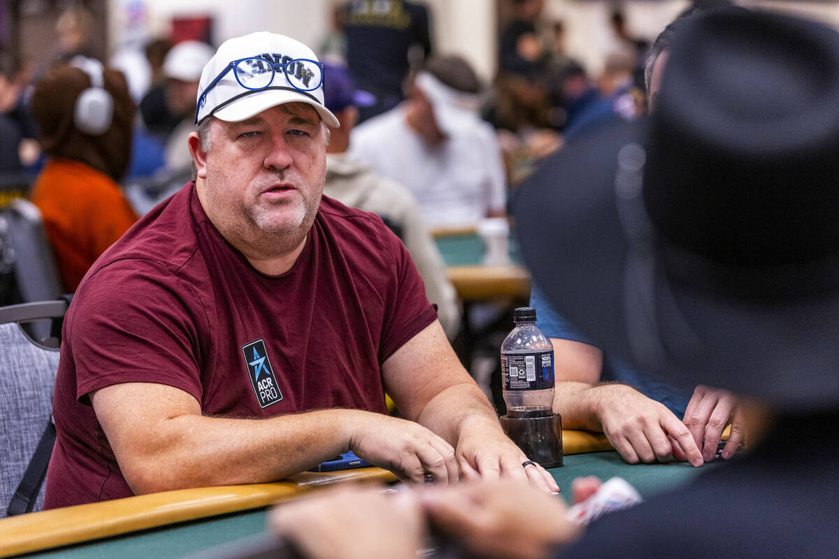 Poker professional Chris Moneymaker chats with others at his table during the opening day of th ...