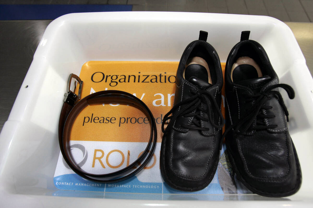 In this Wednesday, Jan. 10, 2007, file photo, a belt and shoes sit in a trays with advertising ...