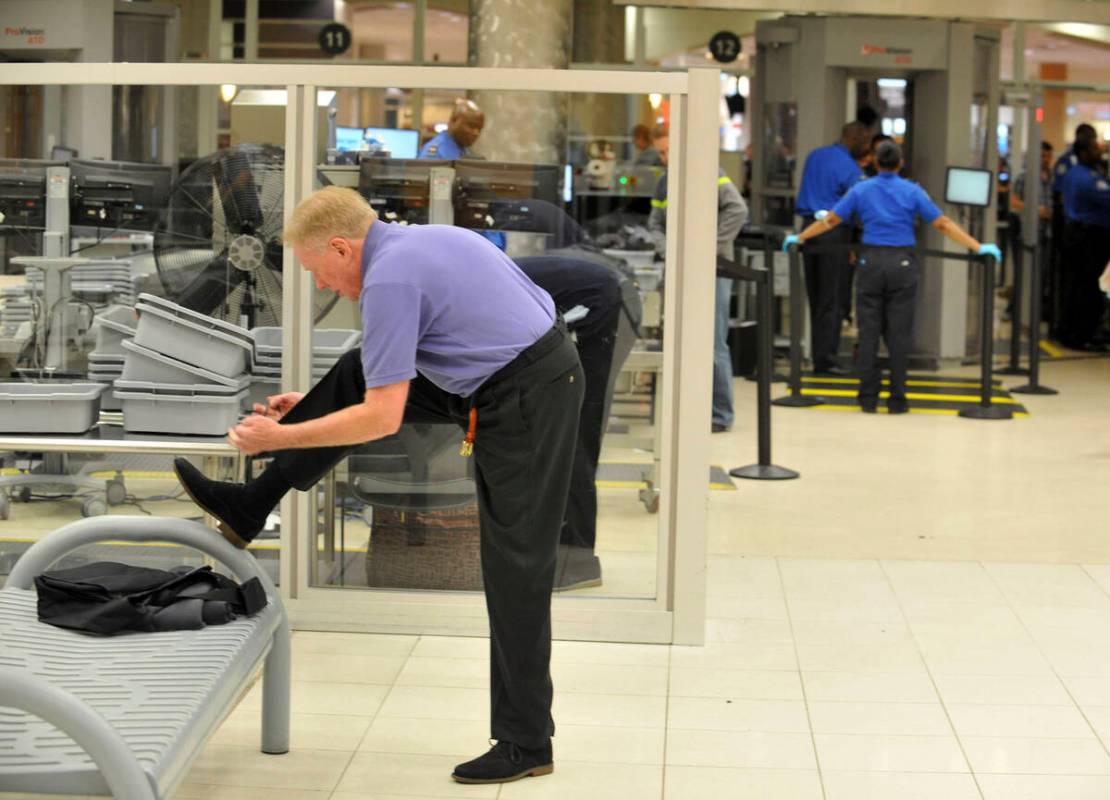 A traveler removes his shoes at Hartsfield-Jackson Atlanta International Airport on Wednesday, ...