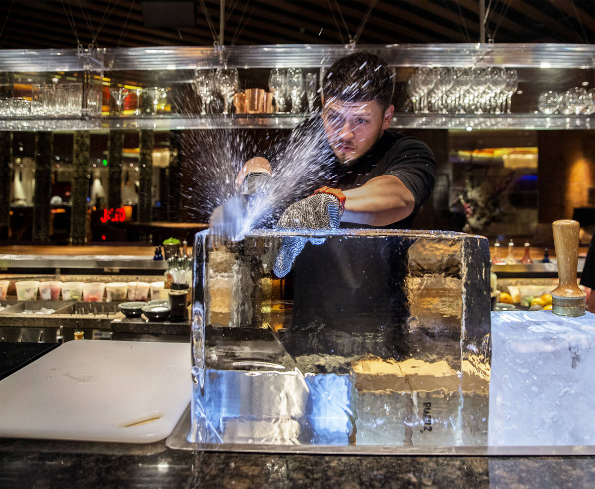 Barback Danny Padilla carves ice for a Japanese Old Fashion cocktail at Zuma on Monday, Aug., 6 ...