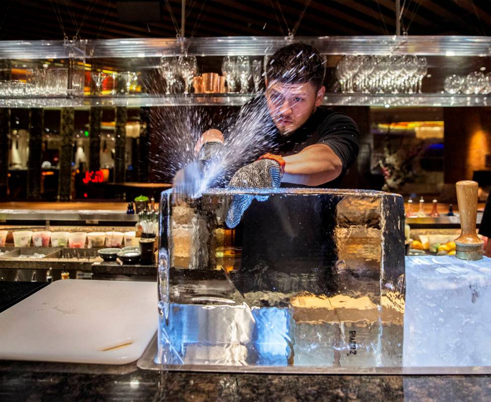 Barback Danny Padilla carves ice for a Japanese Old Fashion cocktail at Zuma on Monday, Aug., 6 ...