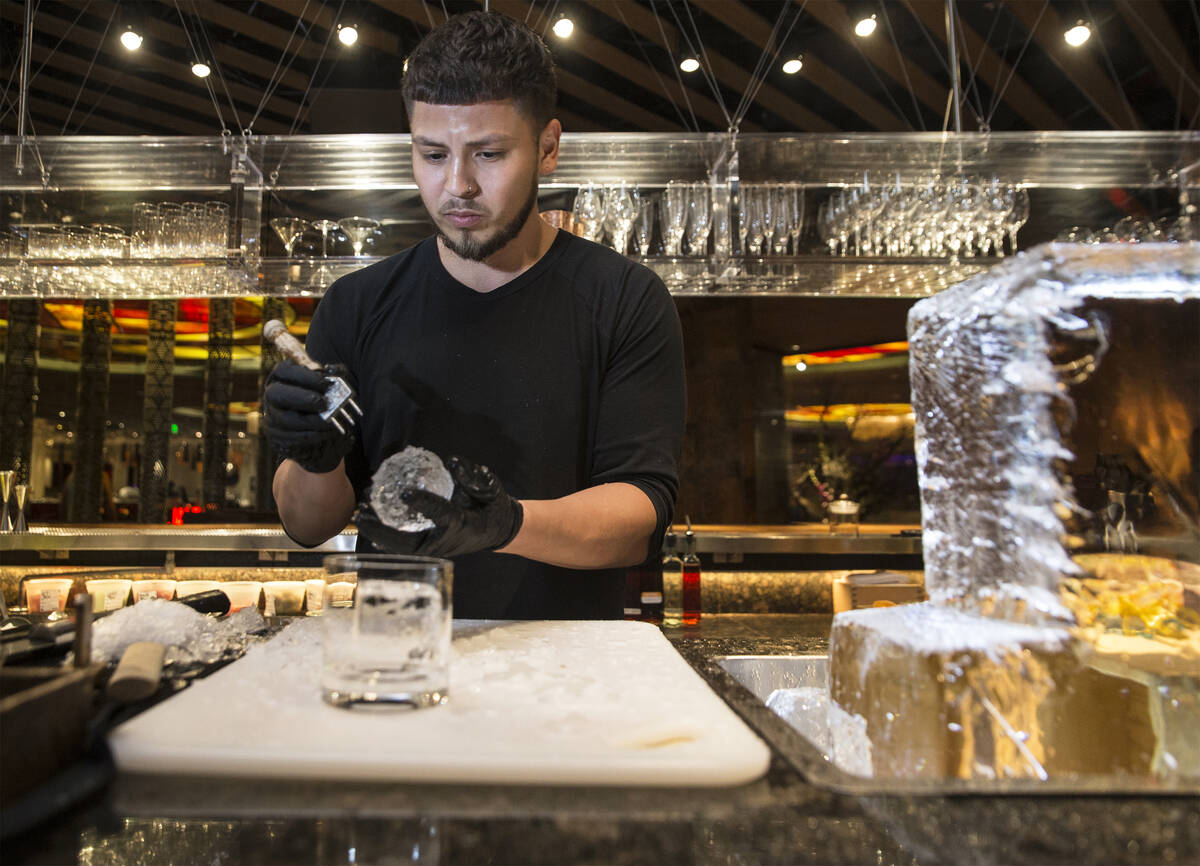 Barback Danny Padilla carves ice for a Japanese Old Fashion cocktail at Zuma on Monday, Aug., 6 ...