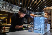 Barback Danny Padilla carves ice for a Japanese Old Fashion cocktail at Zuma on Monday, Aug., 6 ...