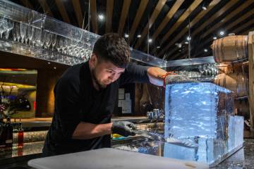 Barback Danny Padilla carves ice for a Japanese Old Fashion cocktail at Zuma on Monday, Aug., 6 ...