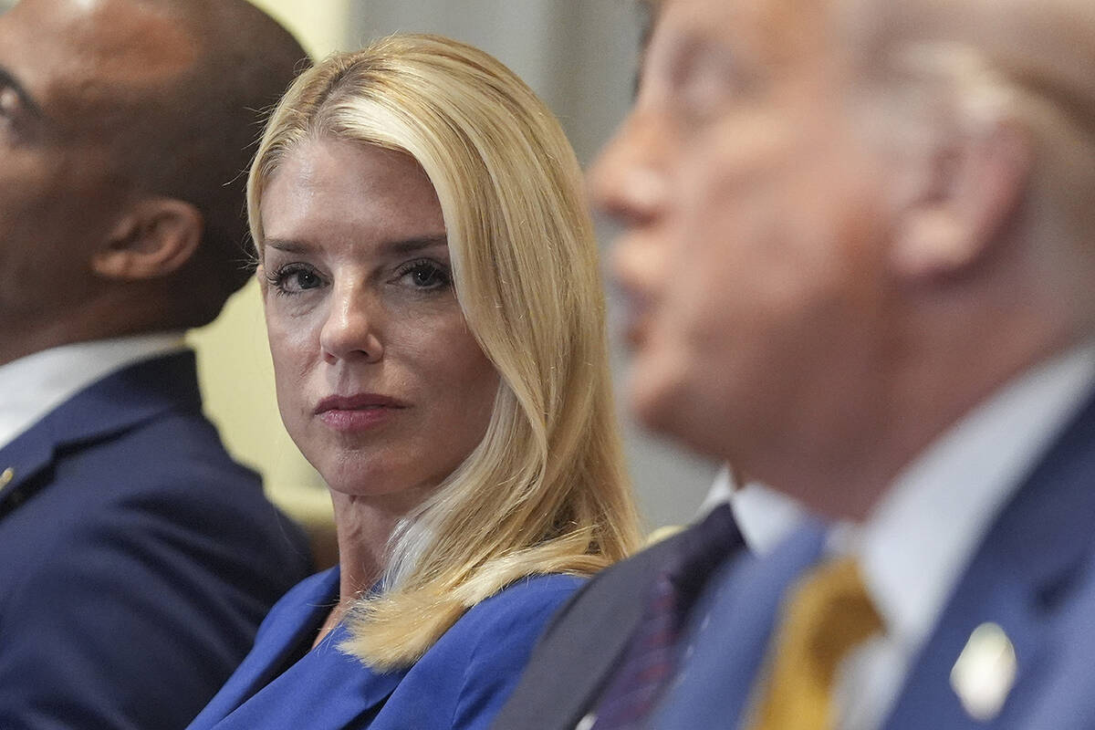 Attorney General Pam Bondi, left, listens as President Donald Trump, right, speaks during a cab ...