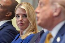 Attorney General Pam Bondi, left, listens as President Donald Trump, right, speaks during a cab ...
