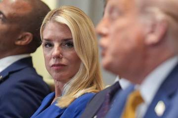 Attorney General Pam Bondi, left, listens as President Donald Trump, right, speaks during a cab ...
