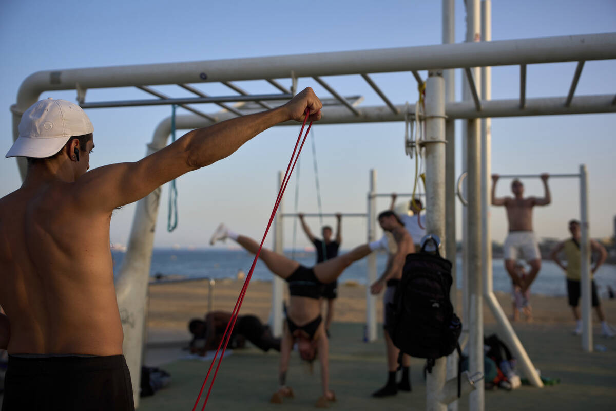 People work out in an open-air gym next to the beach in Barcelona, Spain, Tuesday, June 25, 202 ...