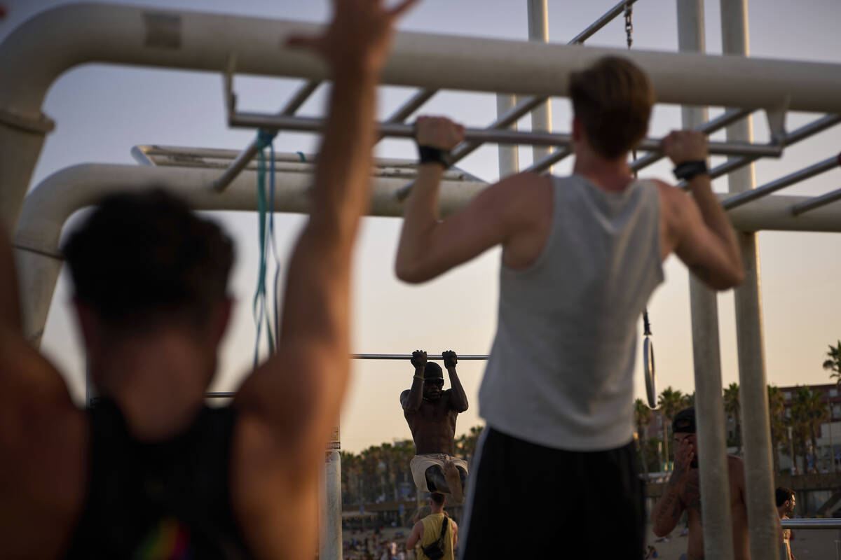 People work out in an open-air gym next to the beach in Barcelona, Spain, Tuesday, June 25, 202 ...