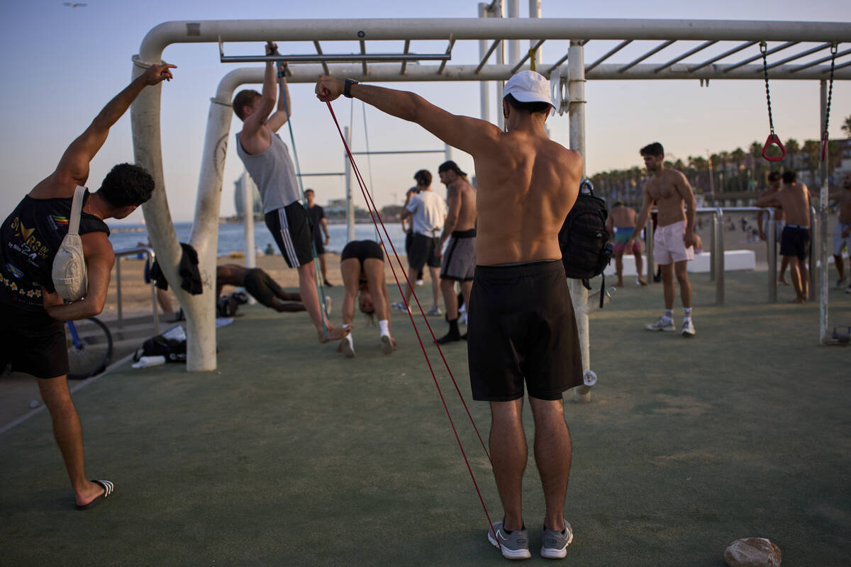 People work out in an open-air gym next to the beach in Barcelona, Spain, Tuesday, June 25, 202 ...