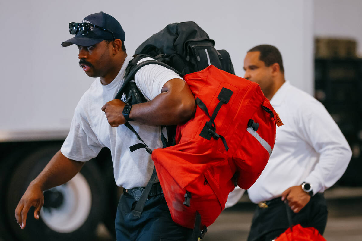 Members of Nevada Task Force 1 pack their personal belongings as they prepare to deploy to Texa ...