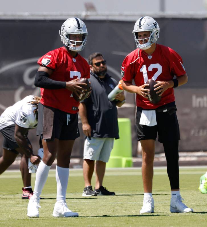 Raiders quarterbacks Geno Smith (7) and Aidan O'Connell (12) discuss during the last day of an ...