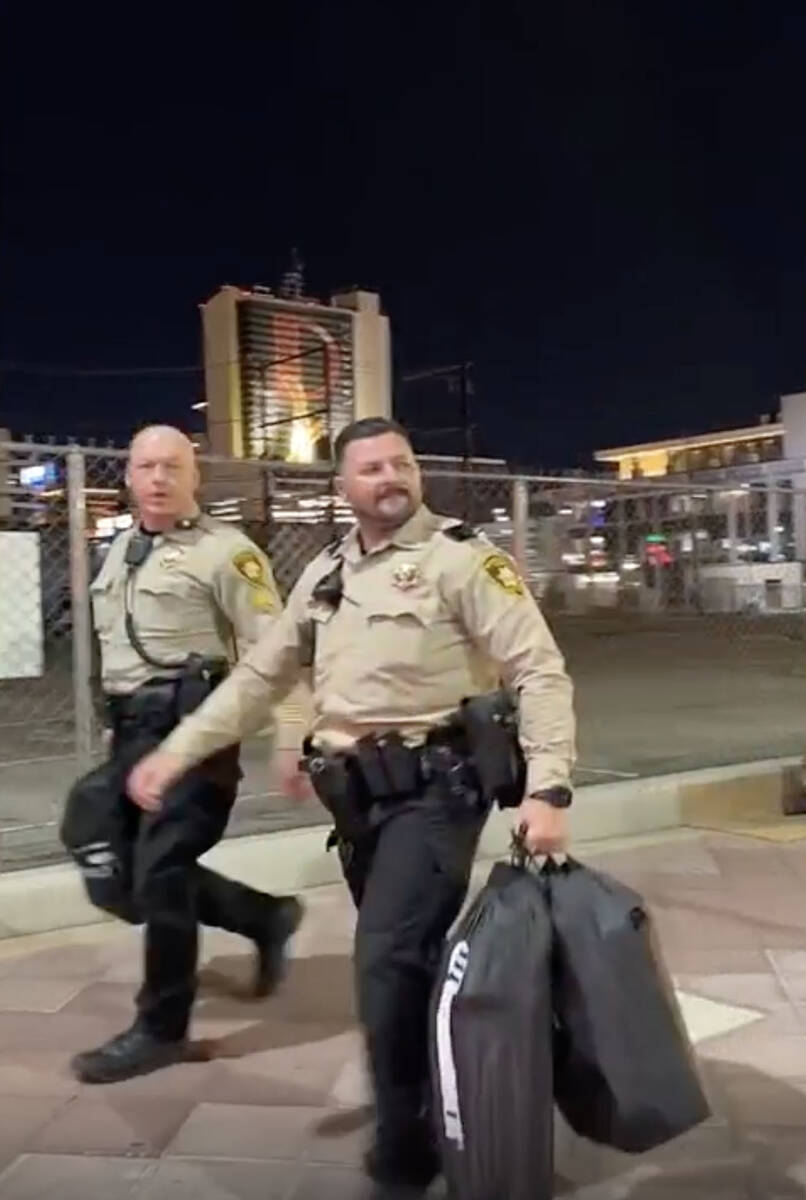 This video screenshot shows Metro officers walking past Karlin Martinez and Cesar Corrales befo ...