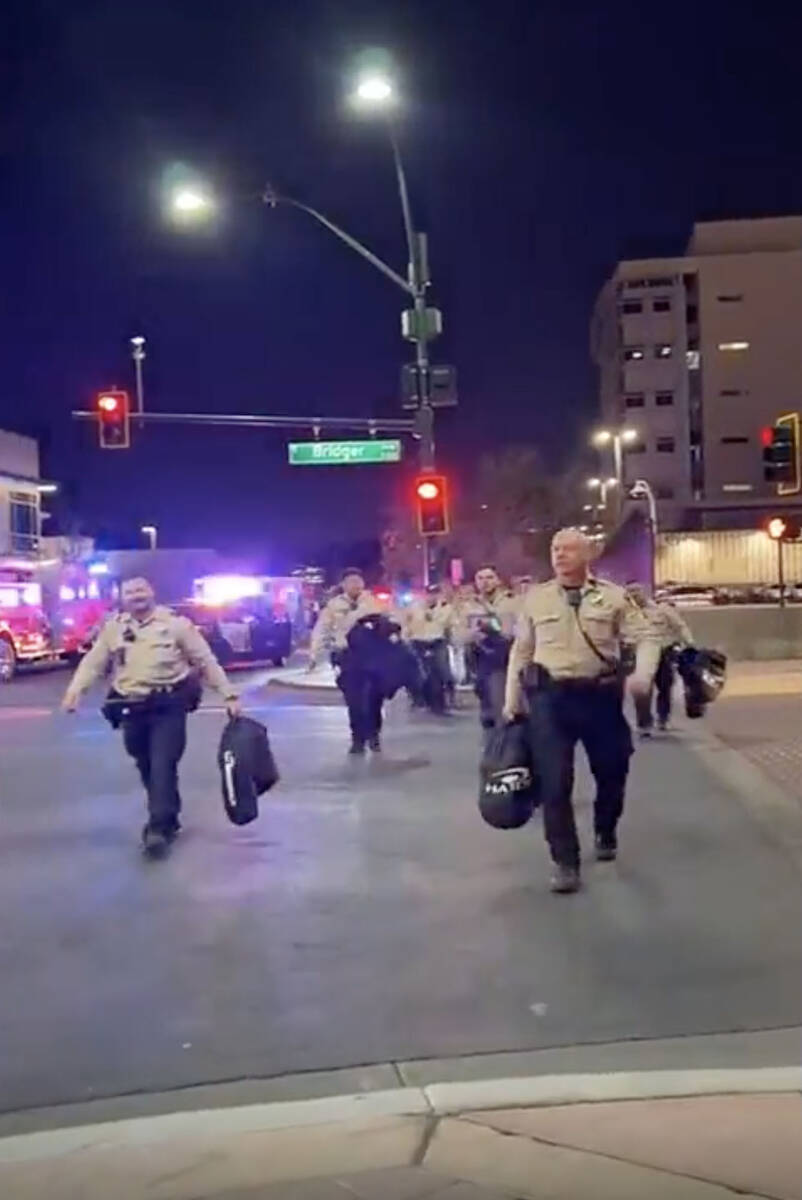 This video screenshot shows Metro officers approaching Karlin Martinez and Cesar Corrales to ma ...