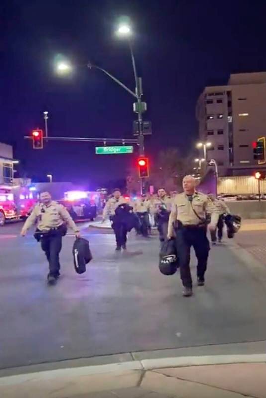 This video screenshot shows Metro officers approaching Karlin Martinez and Cesar Corrales to ma ...