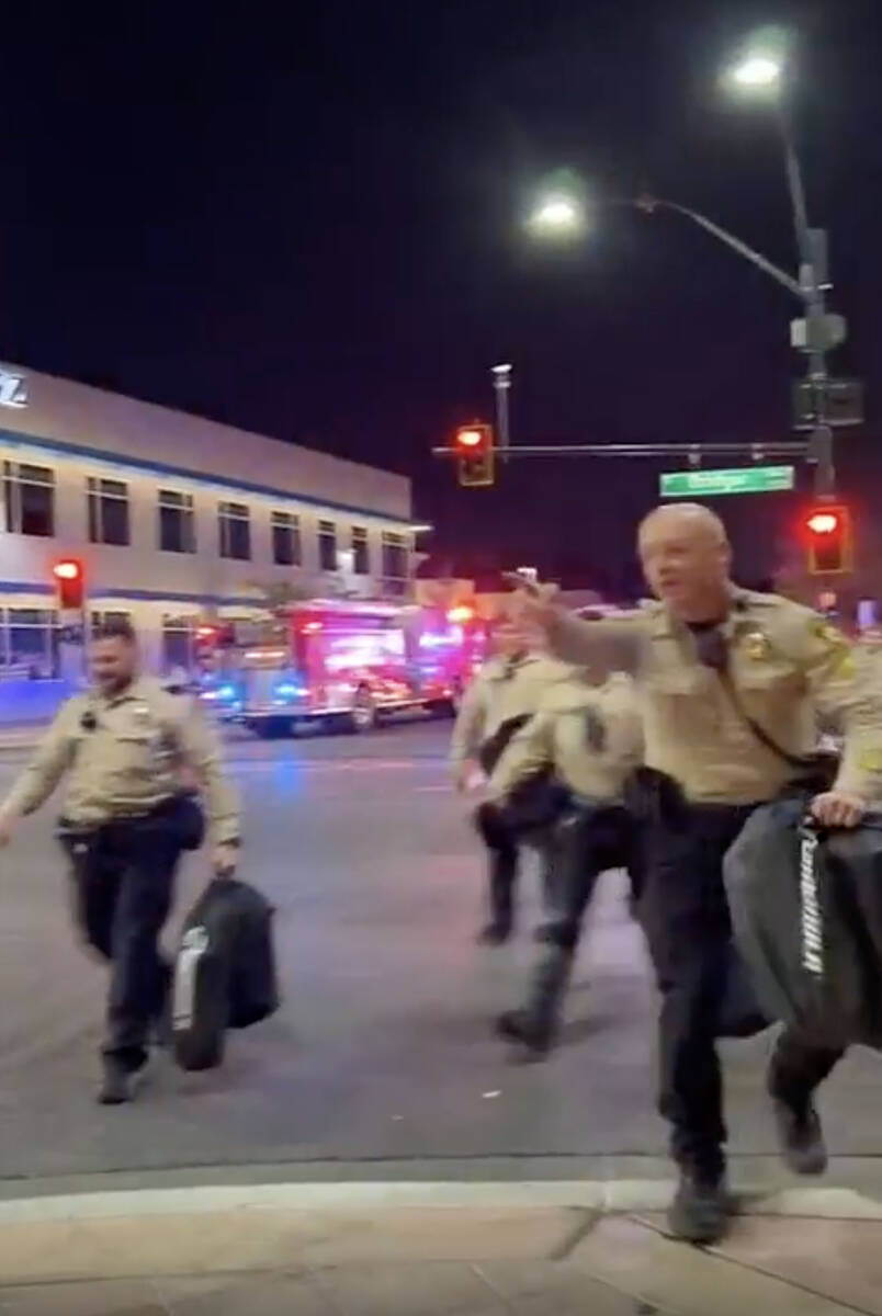 This video screenshot shows Metro officers approaching Karlin Martinez and Cesar Corrales to ma ...