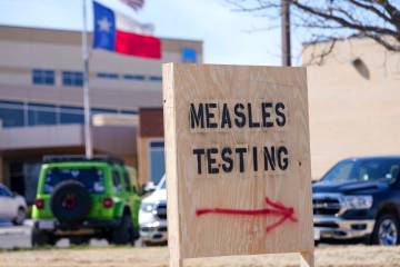 FILE - A sign is displayed outside the Seminole Hospital District offering measles testing, Feb ...