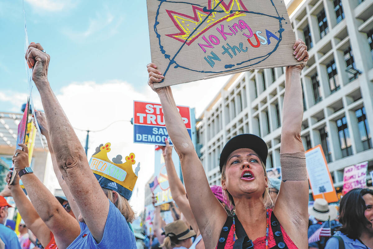 Protestors shout during a national “No Kings” protest in the downtown area Saturd ...