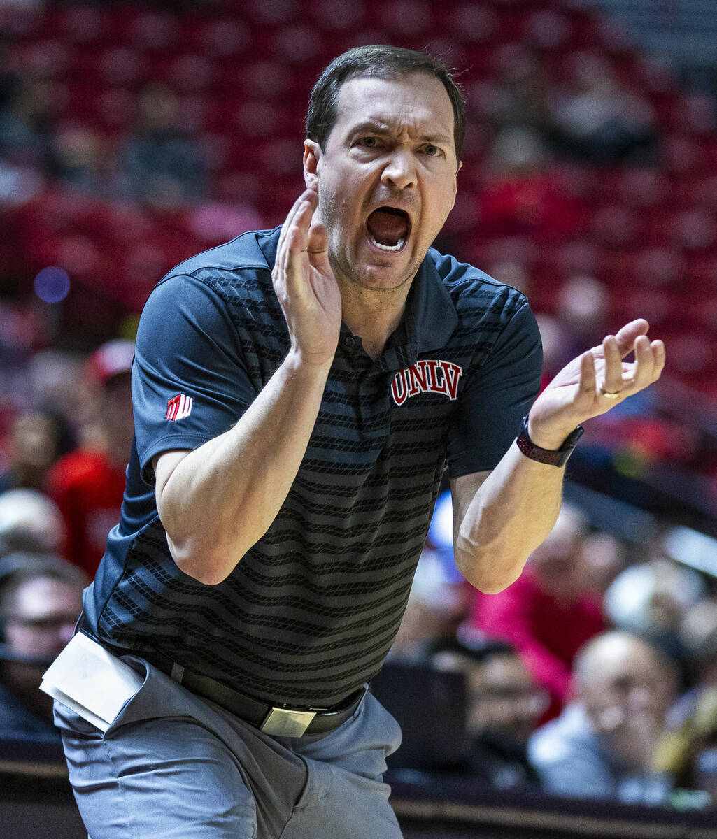 UNLV head coach Kevin Kruger works to motivate his team as they fall behind the Wyoming Cowboys ...