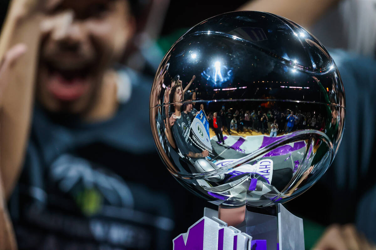 The Colorado State Rams basketball team is reflected into the Mountain West championship trophy ...