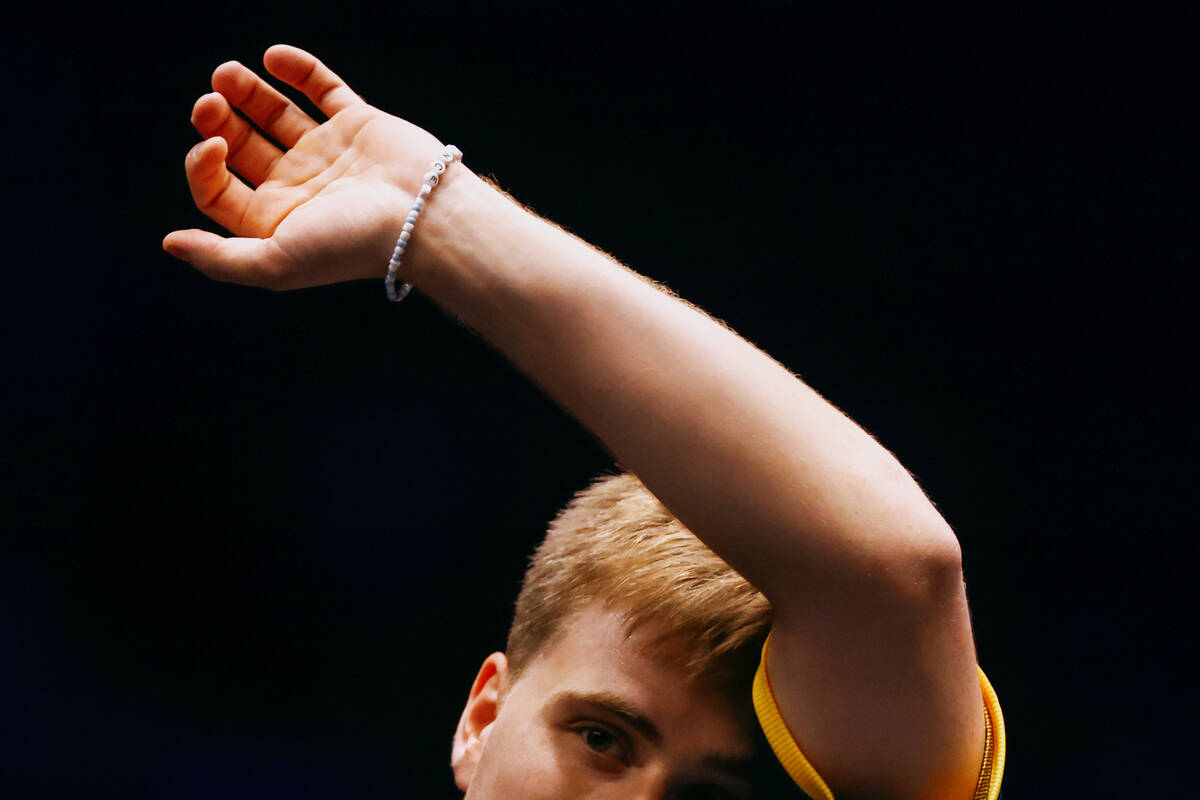 Truls Moregard of Sweden wipes his face on his sleeve while playing against Yuta Tanaka of Japa ...