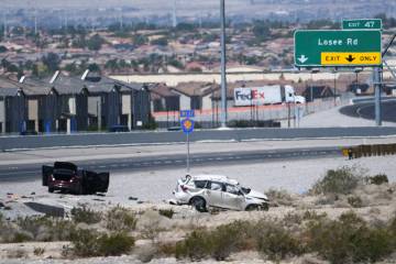 Vehicles are seen off the side of Interstate 215 between Pecos and Losee Roads after a fatal cr ...