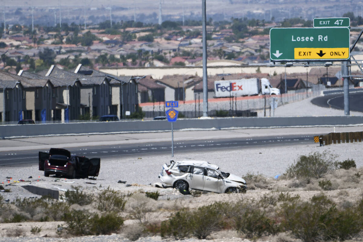 Vehicles are seen off the side of Interstate 215 between Pecos and Losee Roads after a fatal cr ...